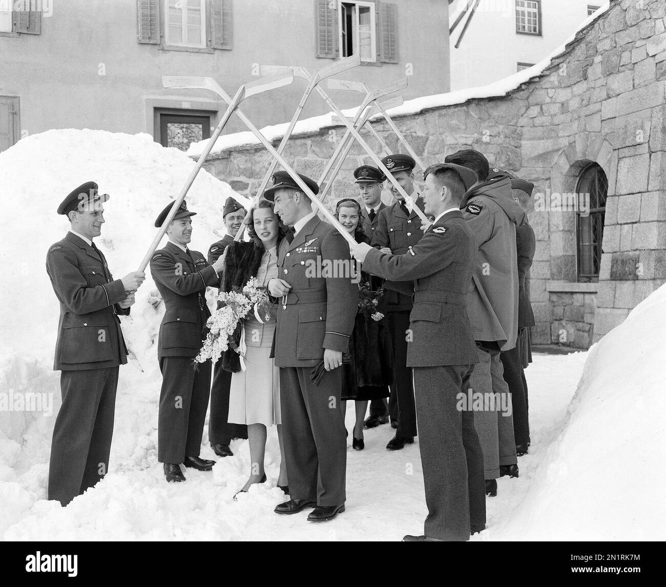 News Photo: R.C.A.F. Flyers Hold Arch of Hockey Sticks As Newly Weds Birthe and Hubert Brooks Exit Church